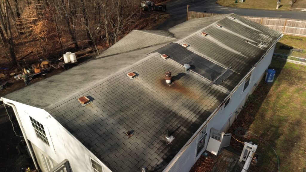 A before image of Walter Hummel's home, with leaking roof and tarp.