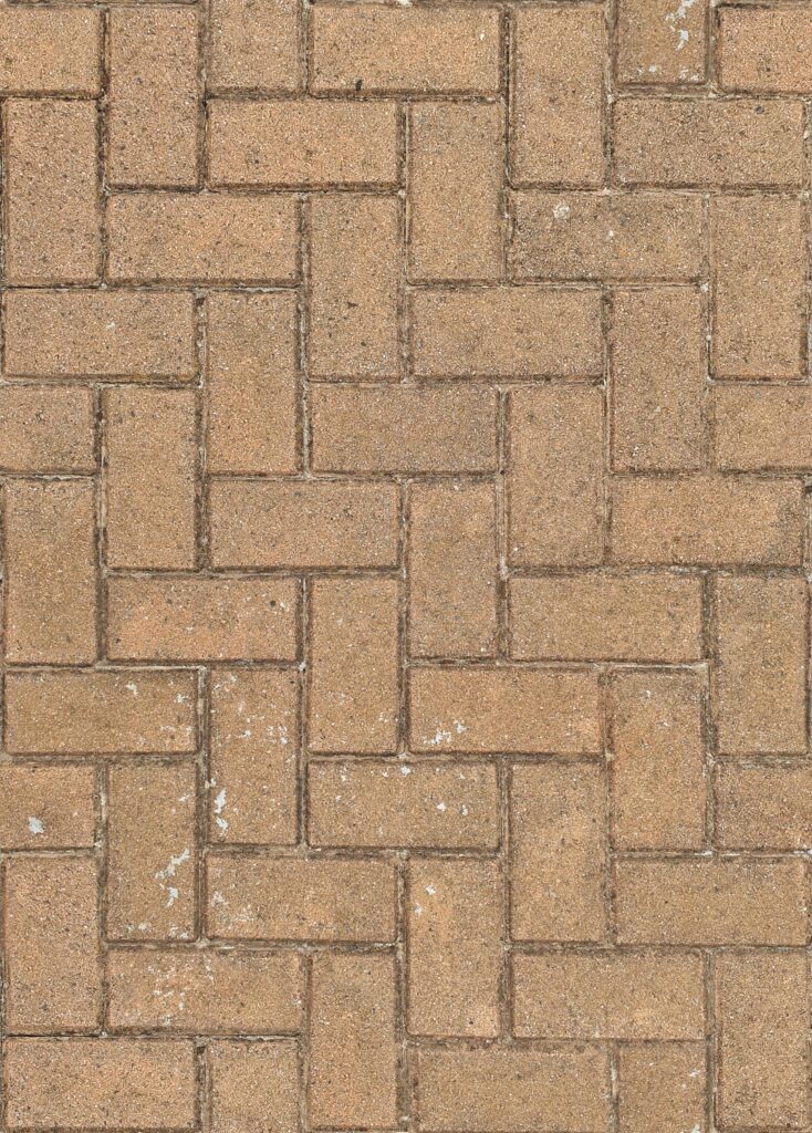 Top view of herringbone brick pavement pattern, ideal for backgrounds.