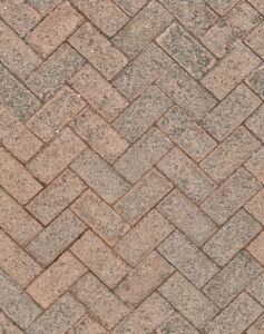 Close-up of herringbone patterned brick pavement, ideal for background texture.