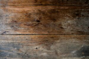 Close-up view of a rustic wooden plank with a textured, weathered finish ideal for backgrounds.