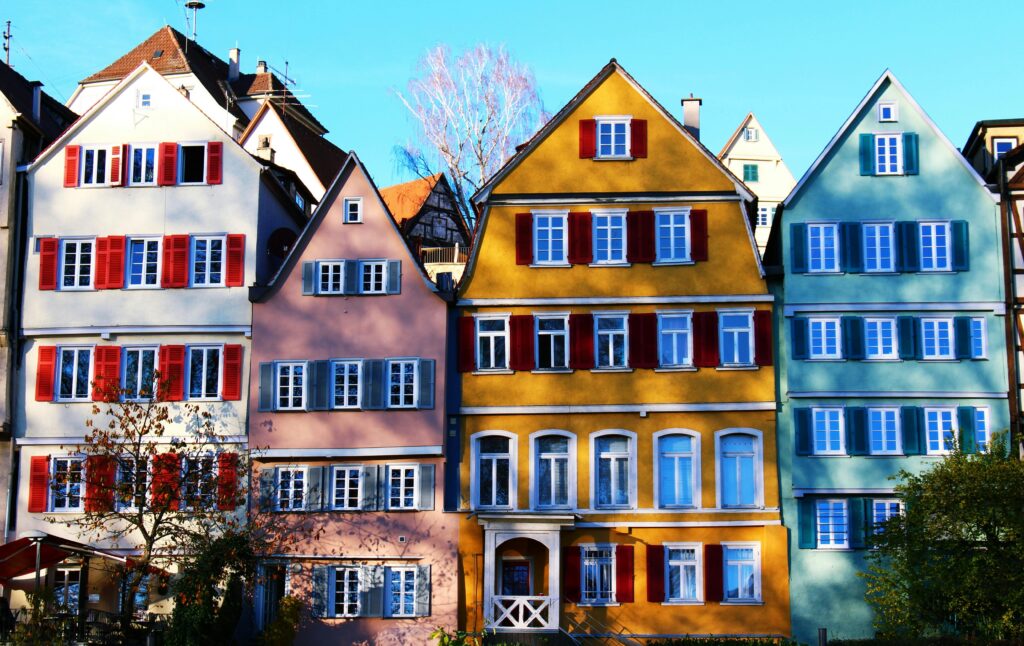 Vibrant facades of traditional houses in Tübingen's historic center, under a clear daytime sky.