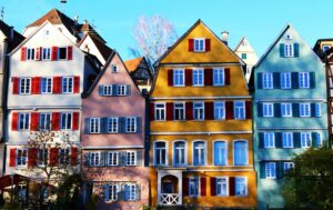Vibrant facades of traditional houses in Tübingen's historic center, under a clear daytime sky.