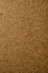 Close-up of a natural corkboard texture perfect for backgrounds and designs.