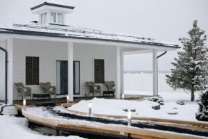 A cozy modern cabin surrounded by snow, featuring a stylish exterior design.