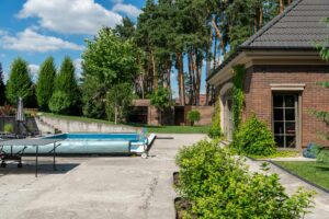Beautiful suburban house with a private pool and lush greenery, perfect for summer relaxation.