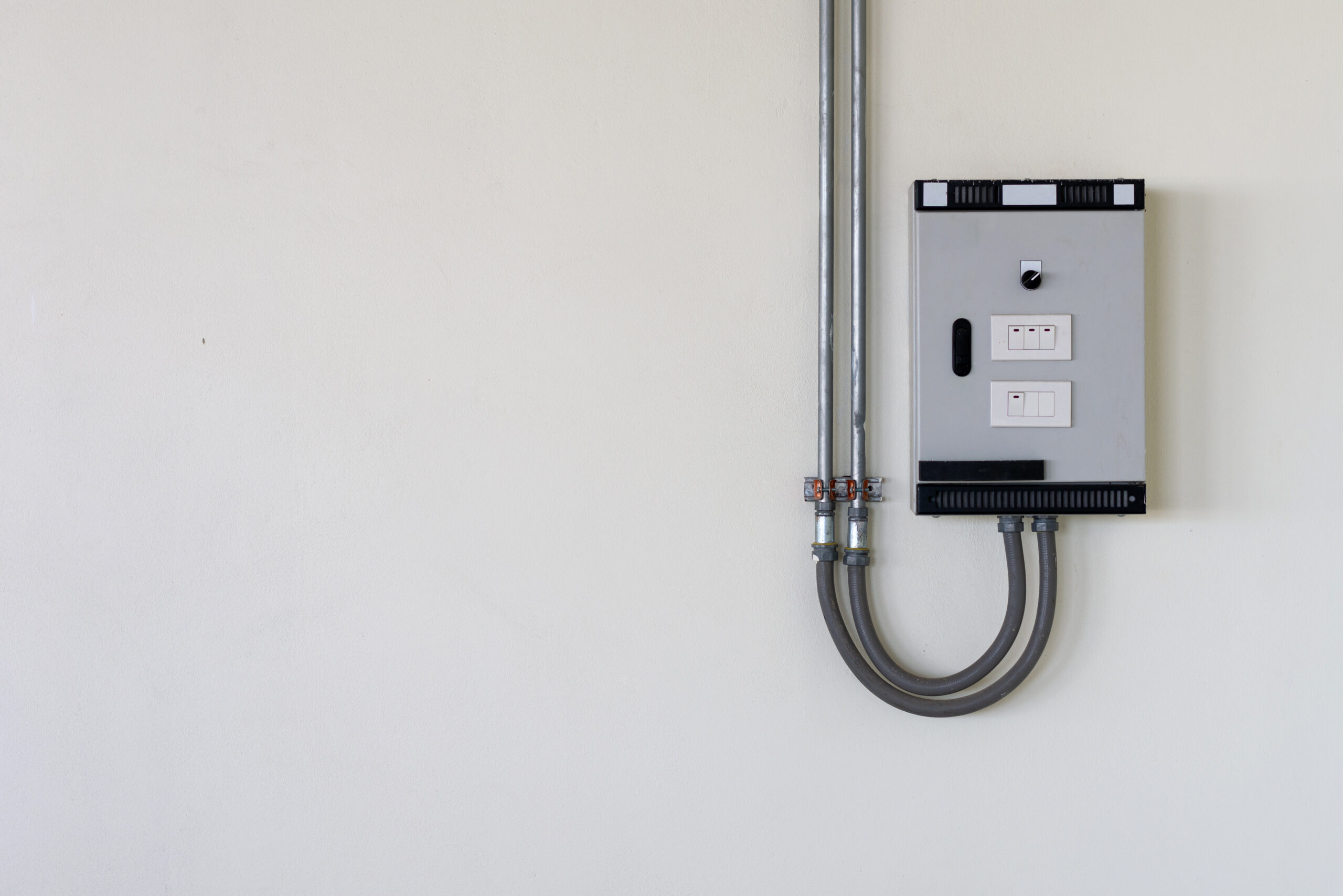 garage interior featuring a dedicated grey electrical subpanel mounted on a finished wall