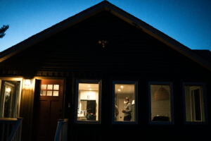 Illuminated home interior visible through a window at night from outside