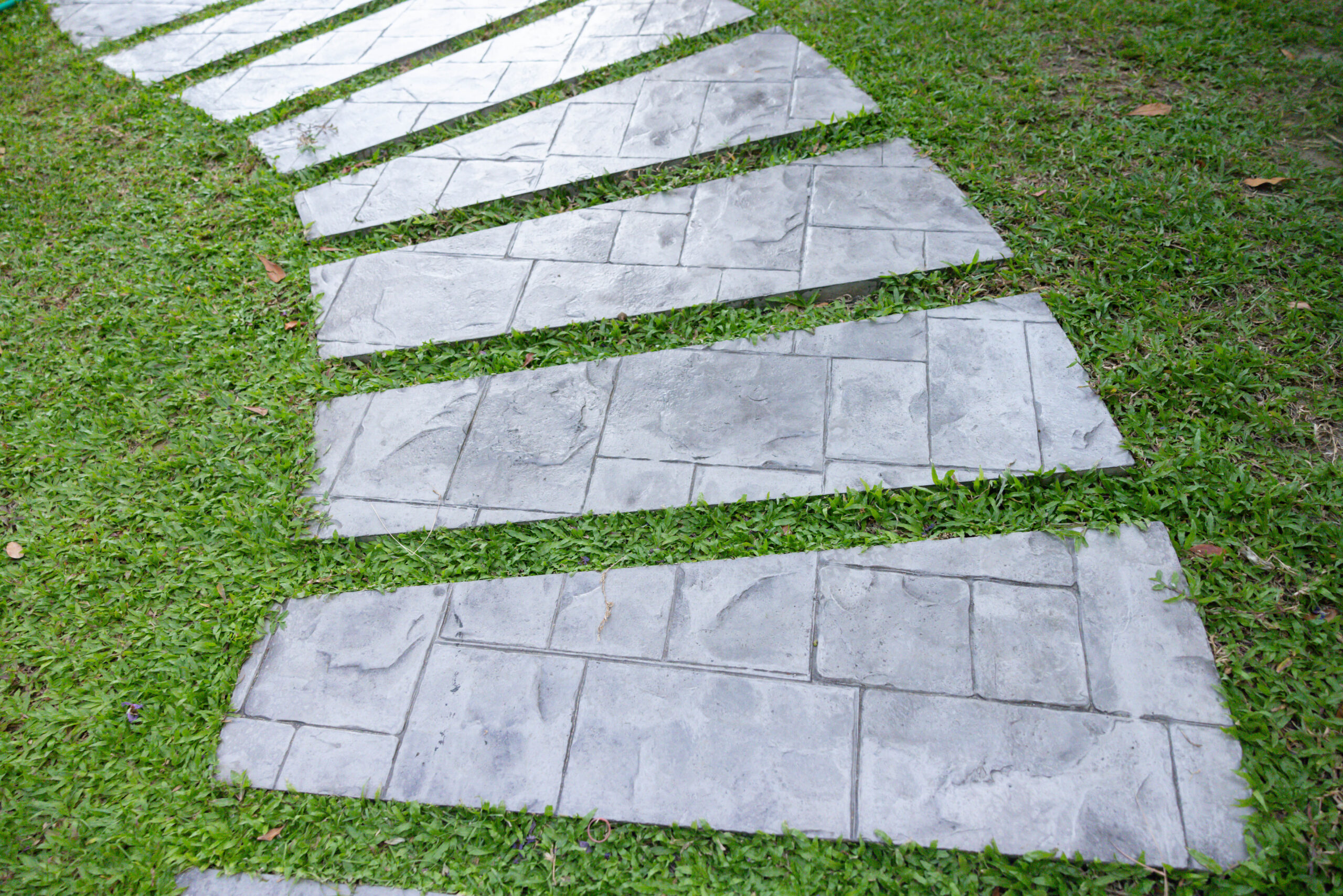 Curved paver pathway through a backyard garden, an example of pavers for backyard flow