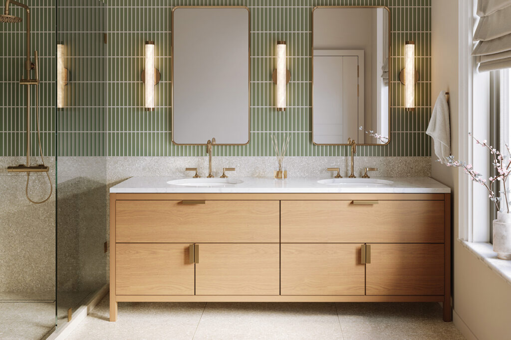 Modern bathroom with a light oak double vanity, sage green tile wall, brass sconces and mirrors, and a walk-in shower