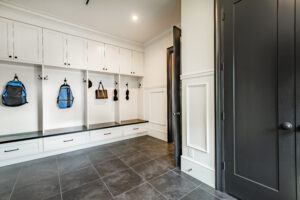 Organized garage mudroom with storage lockers and bench seating