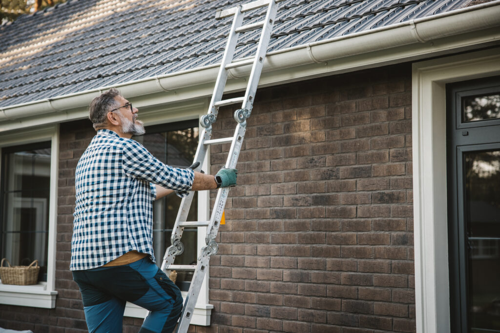 Homeowner inspecting the roof of a home to identify roof problems.