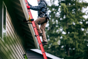 Homeowner inspecting a residential roof before changing weather conditions