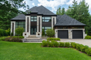 The right roof color boosts curb appeal on a modern home with attractive landscaping.