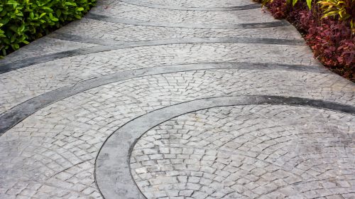 Stamped decorative concrete landscaping patio with earthy tones