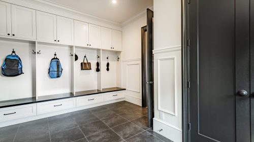 Organized garage mudroom with storage lockers and bench seating