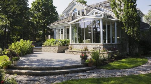 Brick and stone cottage style home with sunroom, patio and landscaped backyard, Quebec, Canada