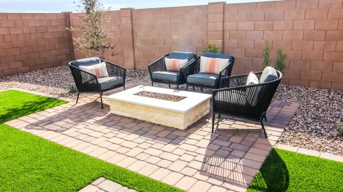 Rear Yard Conversation Area With Four Wicker Chairs On Pavers Patio