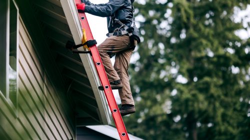 Homeowner inspecting a residential roof before changing weather conditions