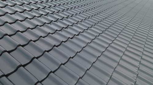Close up of black, burnt roofing on the roof, construction and building concept