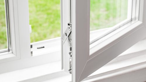 close-up of a modern window showing a sleek security lock and weatherstripping detail.